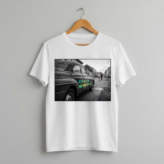 White t-shirt with a black and white photo of a car on a hanger against a gray background with the text Let me be the one who shines with you in graffiti on the car